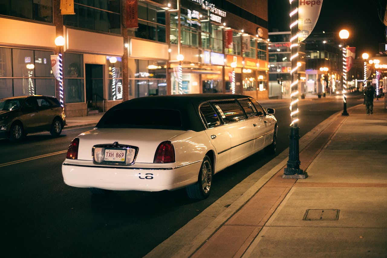 The Art of Drawing Readers In: Your attractive post title goes here White limo with tinted glasses and license plate on roadway against buildings illuminated by street lights in evening city